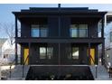 Striking contemporary home with a sleek black facade, balconies, and well-maintained landscaping at 409 Alston St # 101, Raleigh, NC 27601
