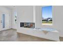 Living room featuring modern fireplace, window bench and sleek herringbone floors at 409 Alston St # 101, Raleigh, NC 27601
