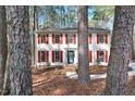Inviting two-story home with a symmetrical facade, red shutters, and a welcoming front entrance at 4910 Highgate Dr, Durham, NC 27713