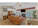 Open-concept living room features a fireplace, vaulted ceilings, and seamless flow into dining area at 5508 Lake Garden Ct, Raleigh, NC 27610