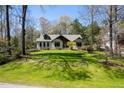 Beautiful home with lush green lawn and mature trees, offering curb appeal and a serene setting at 5512 Deer Hunter Ct, Garner, NC 27529