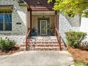 Inviting front porch with brick steps and a covered entryway, leading to the home's entrance at 5512 Deer Hunter Ct, Garner, NC 27529