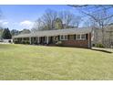 Expansive single-story brick home with a well-maintained lawn, showcasing its generous lot size at 5705 Dean Ave, Raleigh, NC 27616