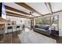 Inviting living room with hardwood floors, wood beams, a fireplace, and an open layout to the kitchen at 5705 Dean Ave, Raleigh, NC 27616