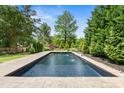 An amazing backyard featuring an inviting swimming pool and pristine landscaping at 5811 Shawood Dr, Raleigh, NC 27609