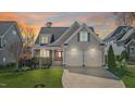 Charming home featuring a two-car garage, and well-maintained landscaping, at sunset at 5811 Shawood Dr, Raleigh, NC 27609