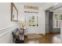 Elegant foyer features hardwood floors, decorative molding, and a charming bench, creating a warm and inviting entrance at 5811 Shawood Dr, Raleigh, NC 27609