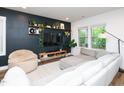Inviting living room with a dark accent wall and plenty of natural light at 606 Great Ridge Pkwy, Chapel Hill, NC 27516