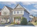 Charming two-story home with a welcoming front porch and well-maintained landscaping at 75 Mallard Landing Dr, Chapel Hill, NC 27516
