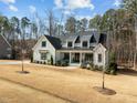 Gorgeous two-story home with manicured lawn, basketball hoop, and a welcoming porch at 76 Gentry Dr, Pittsboro, NC 27312
