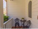 Welcoming front porch featuring brick flooring, cozy wrought-iron seating, and views of the manicured landscaping at 7816 Tylerton Dr, Raleigh, NC 27613