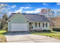 Charming home featuring an attached garage, a welcoming porch, and beautiful landscaping at 803 Trail Stream Way, Knightdale, NC 27545