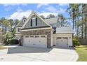 Attached garage with decorative doors, providing ample space for parking and storage at 1033 Jensen Grove Ct, Fuquay Varina, NC 27526
