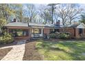 Beautiful brick home with tidy landscaping, black framed windows and brick walkway at 105 Blanchard St, Fuquay Varina, NC 27526