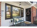 Front porch with black door, house number, dark trim and a bench at 105 Blanchard St, Fuquay Varina, NC 27526