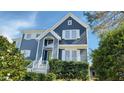 Two story home with gray siding and white trim with a garden in front and visible house number at 105 Cherry Grove Dr, Cary, NC 27519