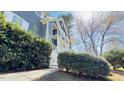 Gray two-story house with a white porch railing and decorative landscaping on a sunny day at 105 Cherry Grove Dr, Cary, NC 27519
