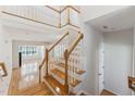Bright foyer with hardwood floors, a staircase and an open floor plan at 11003 Louson Pl, Raleigh, NC 27614