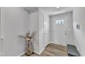 Bright entryway with hardwood floors, white trim, and a decorative vase with floral arrangement at 1107 Pale Moss Dr, Durham, NC 27704