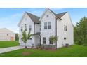 Lovely two-story white home with a spacious two-car garage and lush green lawn providing a picturesque setting at 111 Silver Moon Ln # 121, Clayton, NC 27527