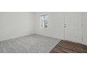 Neutral living room with light gray carpet, wood flooring and a front door at 1114 Centerview Drive, Nashville, NC 27856