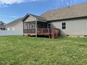 Spacious backyard featuring a screened deck and wooden deck, perfect for outdoor relaxation and entertaining at 115 Pecan Harvest Dr, Garner, NC 27529