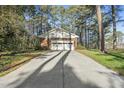 Detached garage with a concrete driveway and ample space for parking and storage at 11801 Strickland Rd, Raleigh, NC 27613