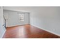 Bright bedroom featuring hardwood floors and a window with natural light at 1248 Jamestown Ct, Cary, NC 27511