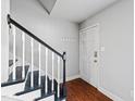 Traditional entryway with stairs, black railing, and sleek hardwood floors at 1248 Jamestown Ct, Cary, NC 27511