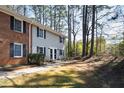 Charming townhouse exteriors with brick accents and natural surroundings at 1248 Jamestown Ct, Cary, NC 27511