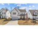 Beautiful two-story home featuring a covered porch, a two-car garage, and an appealing exterior at 1408 Weavers Trace Dr, Zebulon, NC 27597