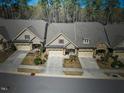 Aerial view of townhouses in neighborhood with manicured yards and mature trees at 147 Glenpark Pl, Cary, NC 27511