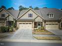Charming townhouse featuring a 2-car garage and manicured landscaping at 147 Glenpark Pl, Cary, NC 27511