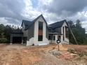 Two-story home with white brick, gray siding and black roof featuring an attached garage at 170 Cherry Bark Dr, Youngsville, NC 27596