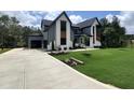 Beautiful modern home with a spacious driveway, lush lawn, and meticulously landscaped yard at 170 Cherry Bark Dr, Youngsville, NC 27596
