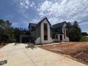 New two-story home features modern architectural design, attached garage, and concrete driveway at 170 Cherry Bark Dr, Youngsville, NC 27596