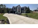 A view of the long driveway leading to a modern two-story house with an attached garage at 170 Cherry Bark Dr, Youngsville, NC 27596