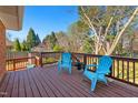Relax on this spacious back deck with blue Adirondack chairs and views of the backyard at 1805 Lawrence Rd, Hillsborough, NC 27278