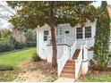 Charming front entrance with brick stairs, white railings, and a well-kept lawn at 1921 Clark Ave # 105, Raleigh, NC 27605