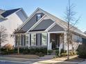 Beautiful gray home with a welcoming front porch, stone accents, and well-maintained landscaping at 2036 Big Falls Dr, Wendell, NC 27591