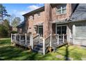 Outdoor wooden deck featuring black metal railings and access to the brick home at 209 Ashmore Ln, Rocky Mount, NC 27804