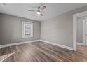 Cozy bedroom featuring wood floors, a ceiling fan, and plenty of natural light at 211 W Sycamore, Zebulon, NC 27597