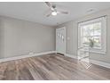 Bright living room with wood floors, modern ceiling fan, and natural light at 211 W Sycamore, Zebulon, NC 27597