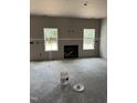 Bright living room showcasing a modern fireplace, drywall, and dual windows bringing in natural light at 228 Dove Rd, Cameron, NC 28326