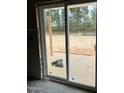 Large sliding glass door allows for natural light and beautiful views of the wooded backyard at 228 Dove Rd, Cameron, NC 28326