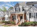 Townhouse exterior features brick accents, light gray siding, white trim, and a neatly landscaped front yard at 2608 Broad Oaks Pl, Raleigh, NC 27603