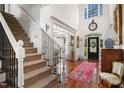 Welcoming foyer features hardwood floors, a grand staircase, and elegant decor at 2613 Forest Lake Ct, Wake Forest, NC 27587