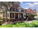Charming brick home featuring a covered front porch with white columns and a well-maintained lawn at 2900 London Bell Dr, Raleigh, NC 27614