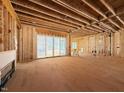 Unfinished living room showcases an open-concept design with sliding glass doors to provide natural light at 2957 Wexford Pond Way, Wake Forest, NC 27587