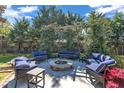 Backyard patio features outdoor seating around a fire pit beneath a vine-covered pergola at 300 Lakeside Dr, Garner, NC 27529